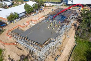 Close up 4K drone video of the INTREC Management Augusta State School concrete slab pour. Amazing footage of the drone flying over wet cement.